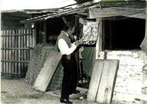 Ele DArtagnan working in front of a cabin behind the old station